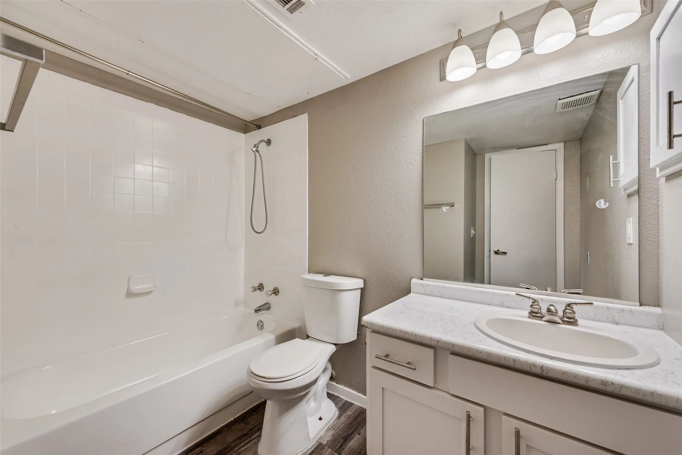 White tile shower and tub combination