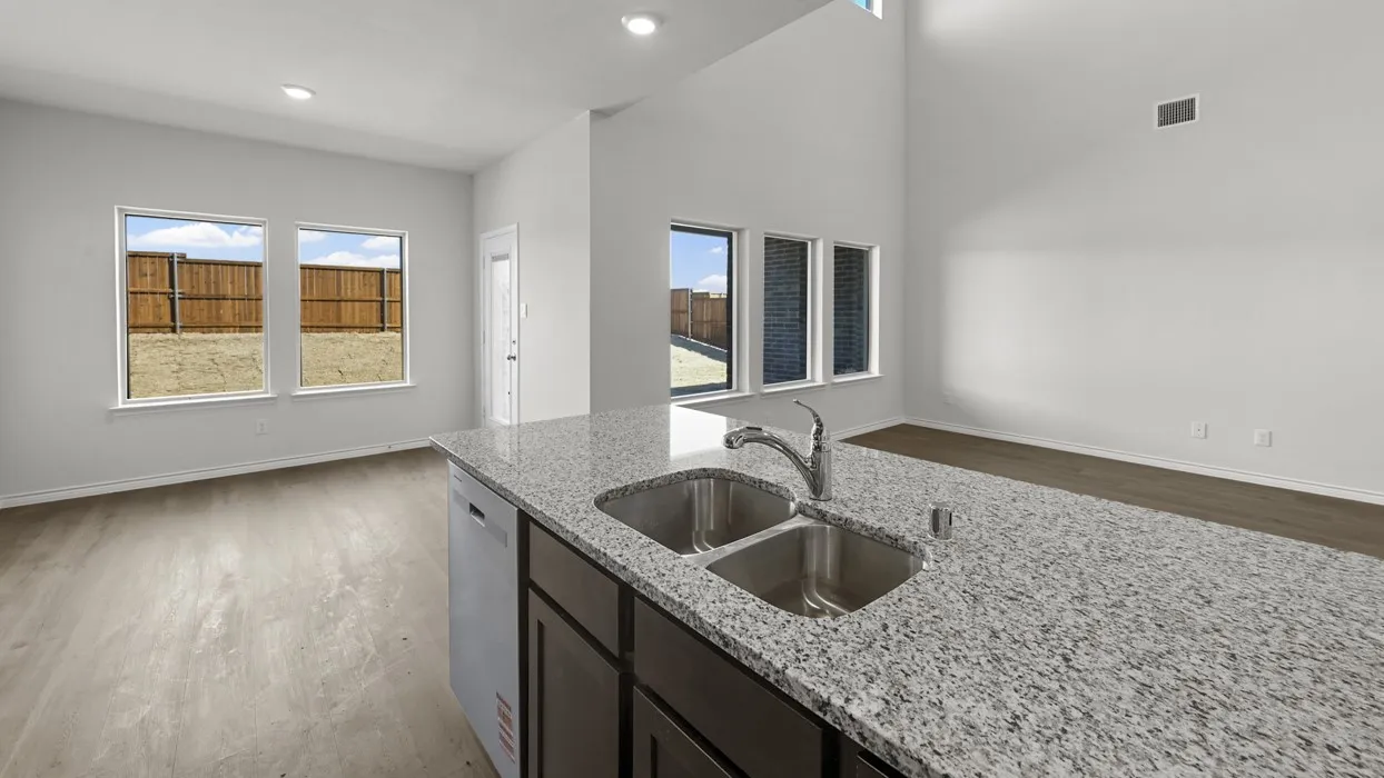 Kitchen island with a double basin stainless steel sink and granite-finish countertop