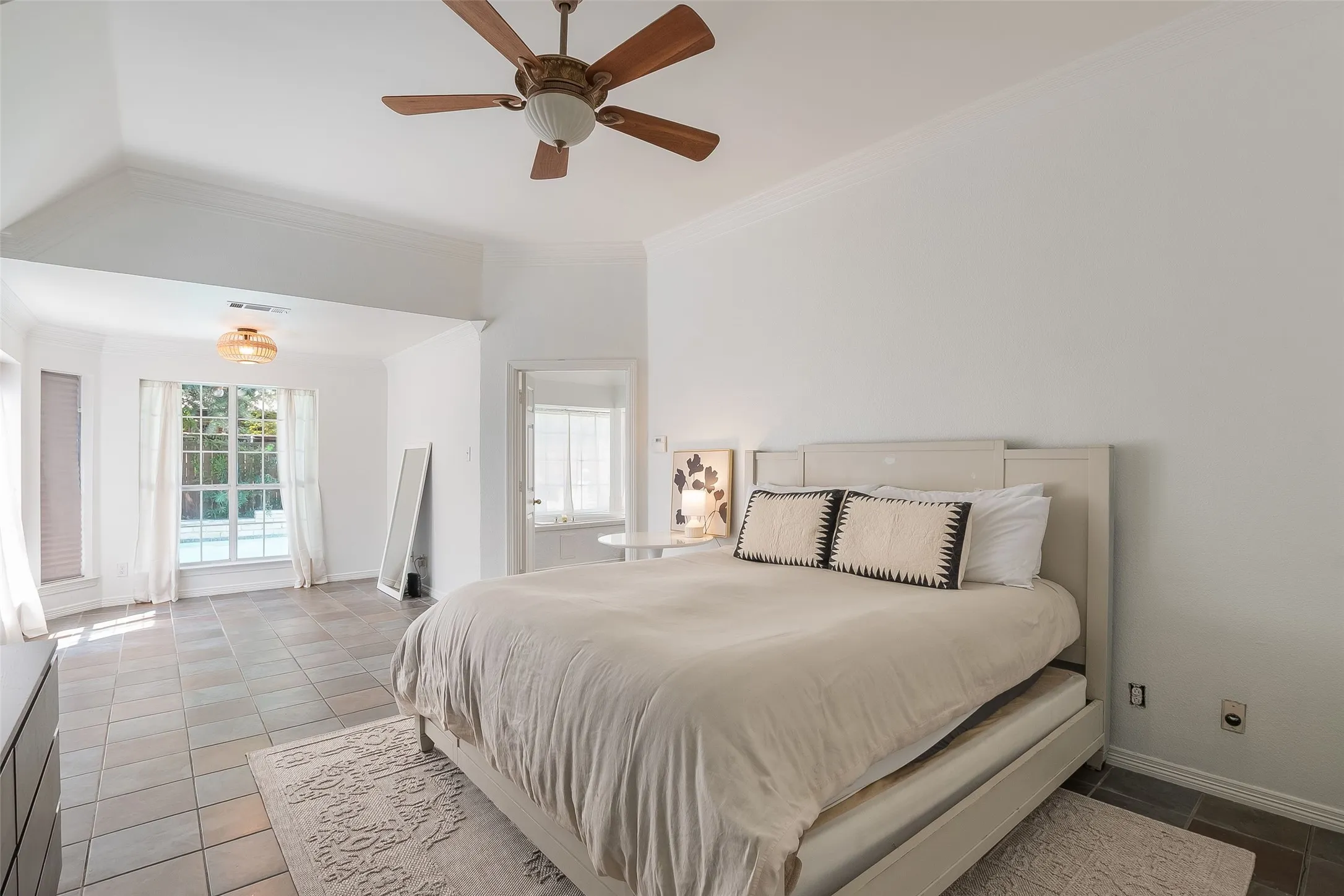 Vaulted ceilings, large bay windows, recessed lighting, ceiling fan, and tile flooring