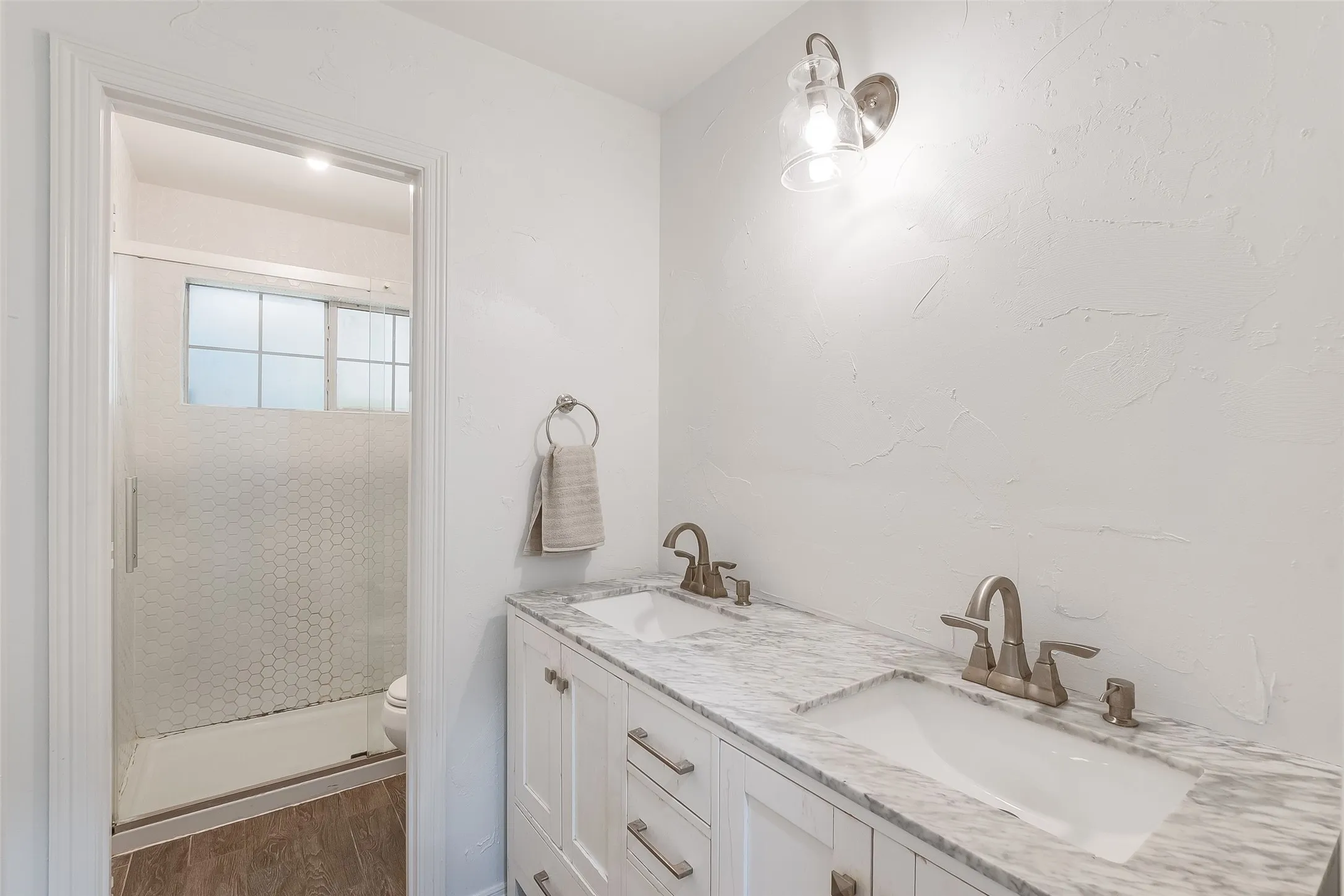 Double vanity with undermount sinks and light-colored countertop