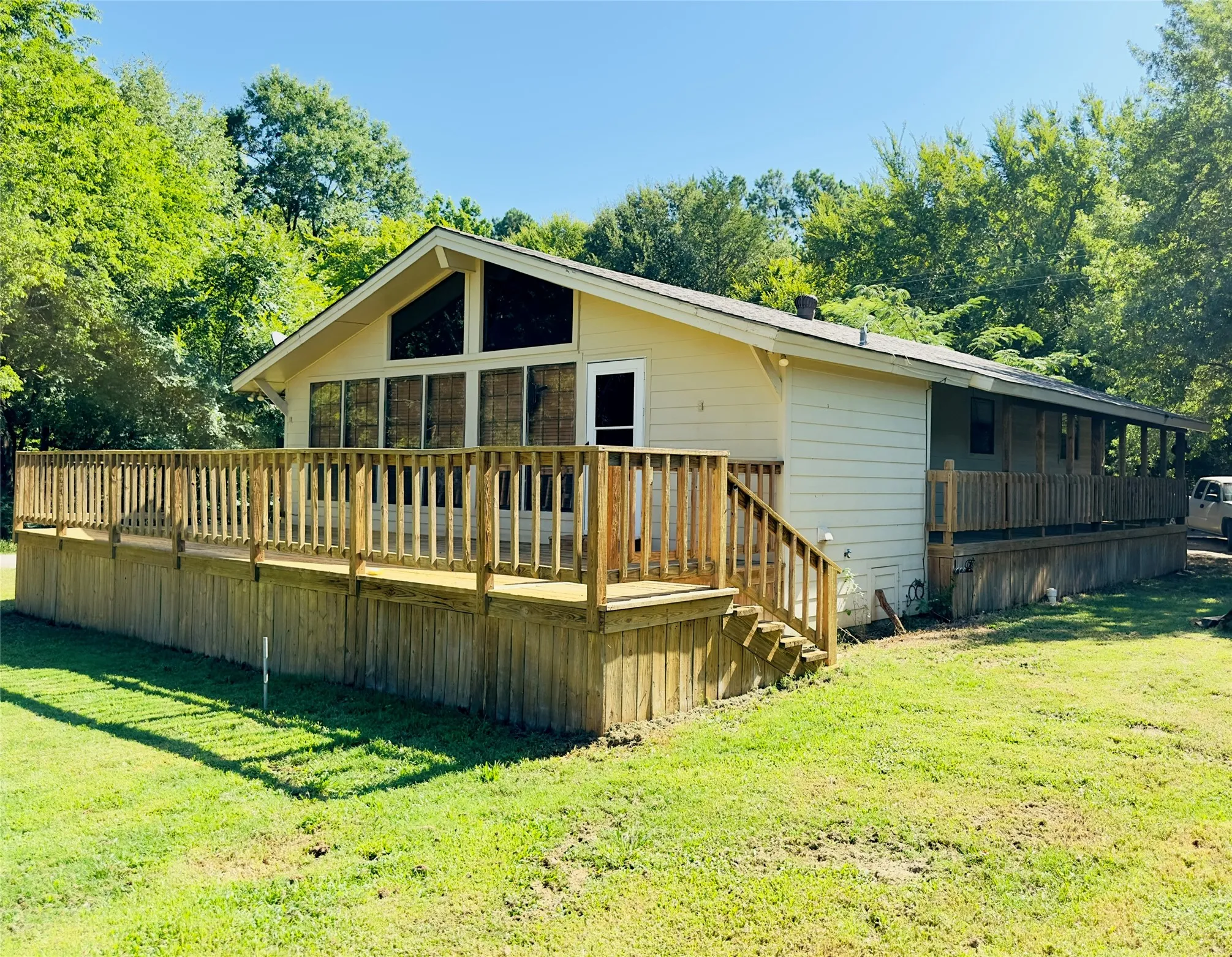 Expansive wood-finish deck with railing and stairs
