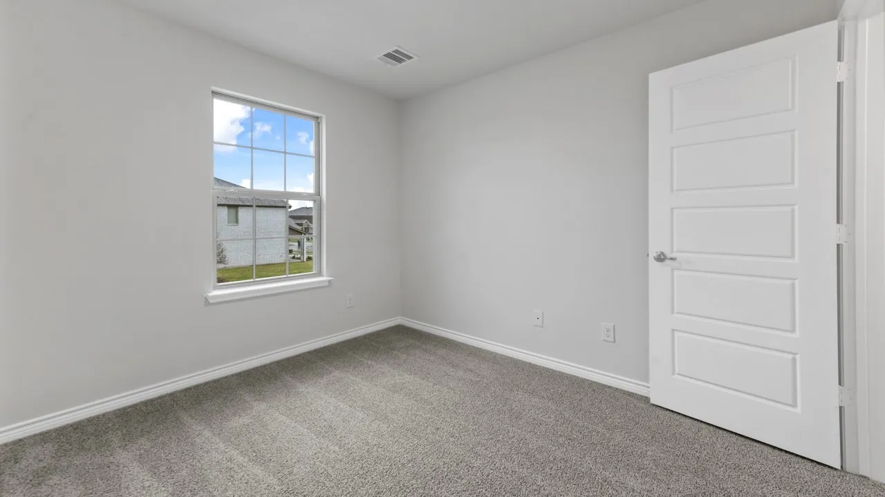 Soft gray carpet, white walls, and a modern five-panel interior door