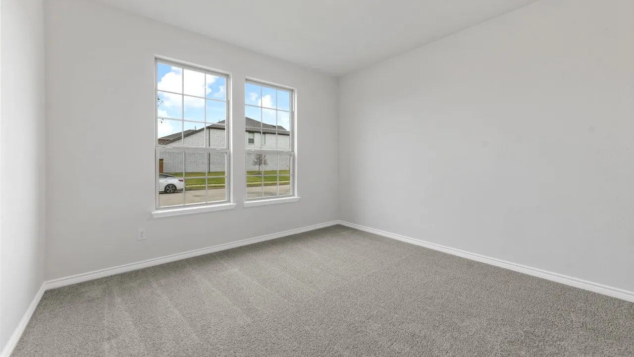 Dual pane windows with grid detailing, neutral carpet, and light-colored wall finish