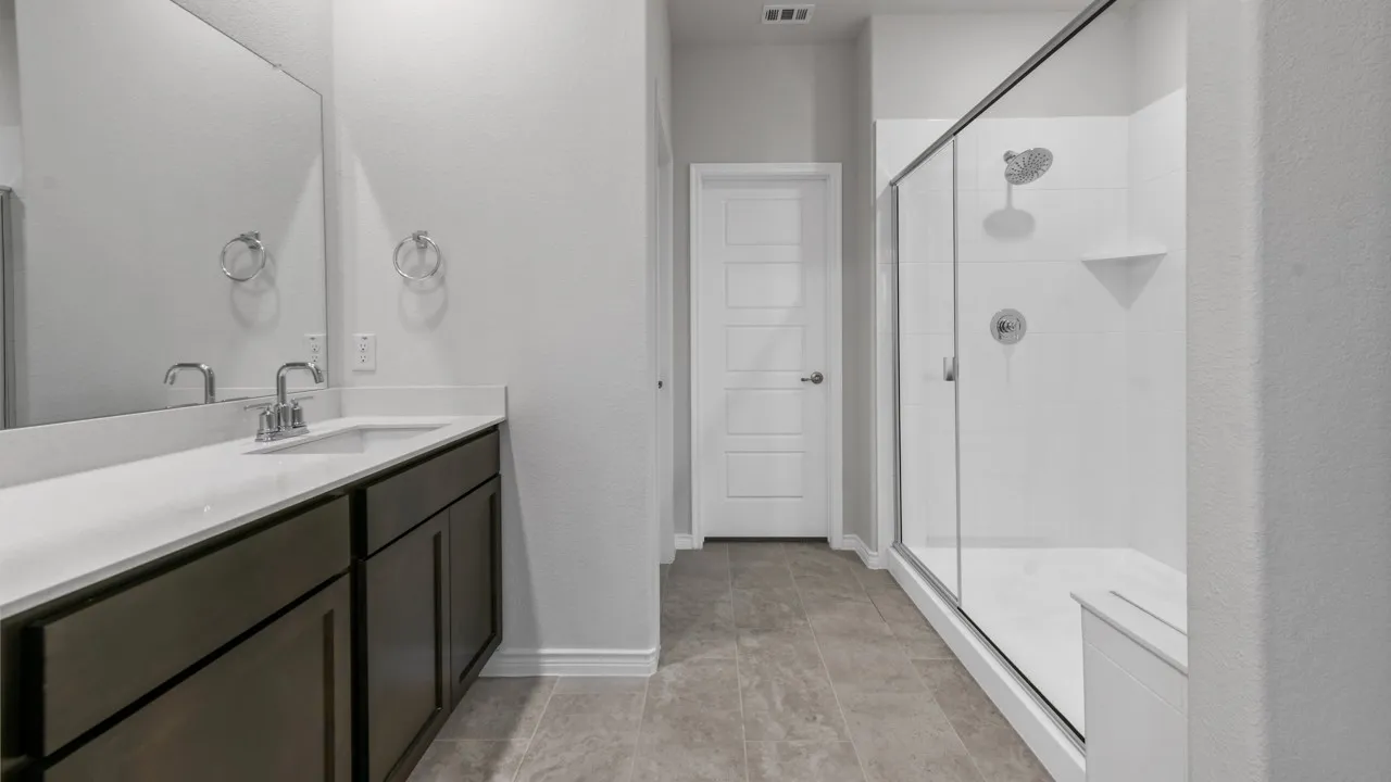 Walk-in shower with a built-in bench, glass enclosure, and white tile surround