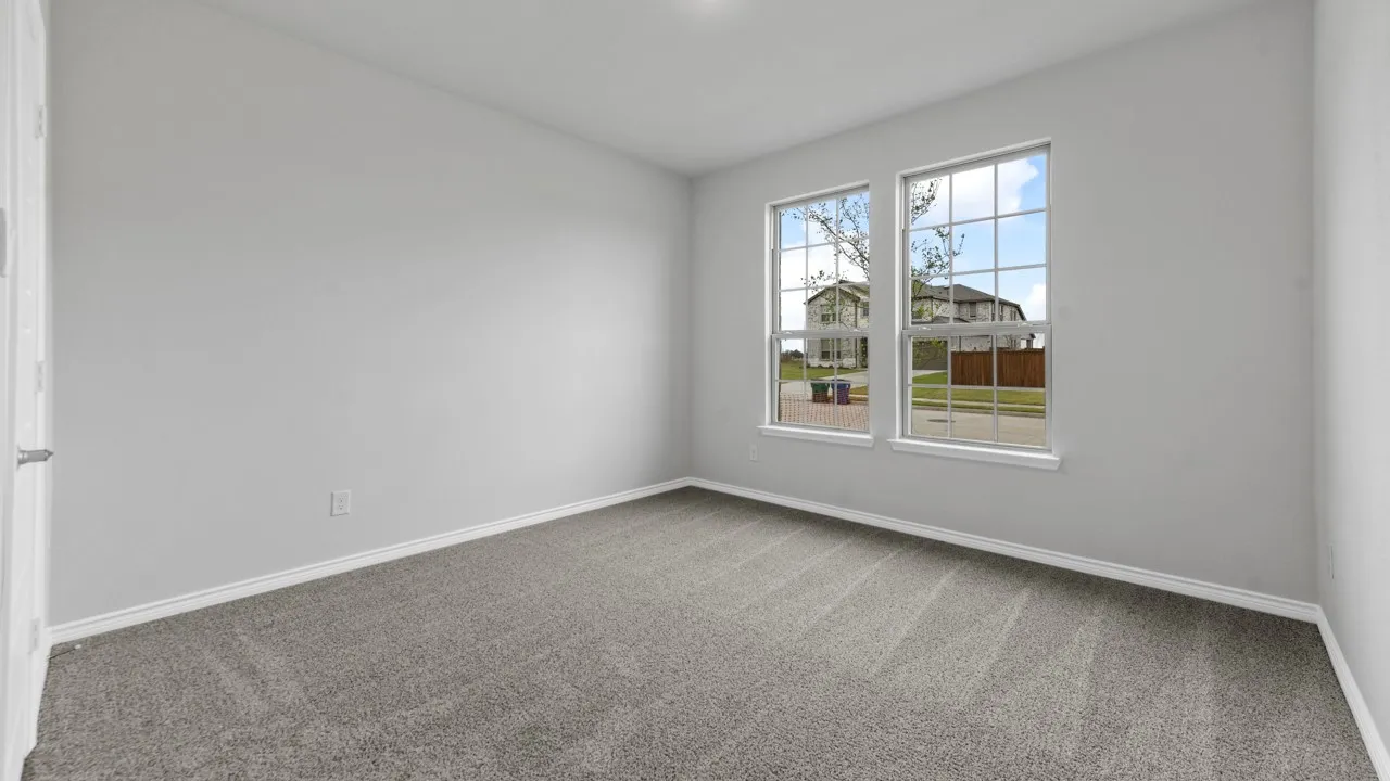 Light gray wall paint, gray carpet flooring, white trim, and two paneled windows with grid inserts