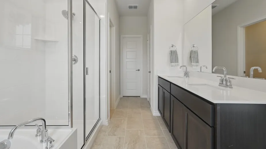 Dual vanity with dark wood-finish cabinetry and light-toned countertops
