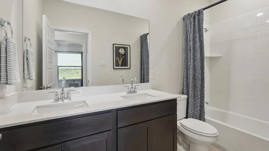 Dual vanity with undermount sinks, chrome fixtures, and a spacious mirror