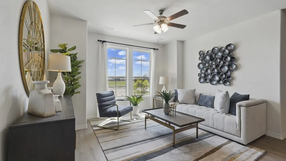 Dual windows with dark trim, wood-finish flooring, and a ceiling fan with integrated lighting