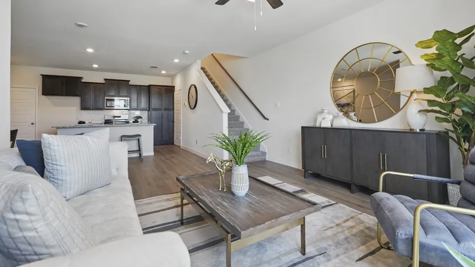 Open-concept living area with wood-finish flooring, recessed lighting, and a ceiling fan