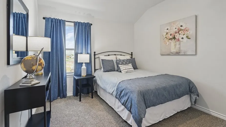 Carpeted room featuring a window with natural light, a pitched ceiling, and a wall-mounted mirror