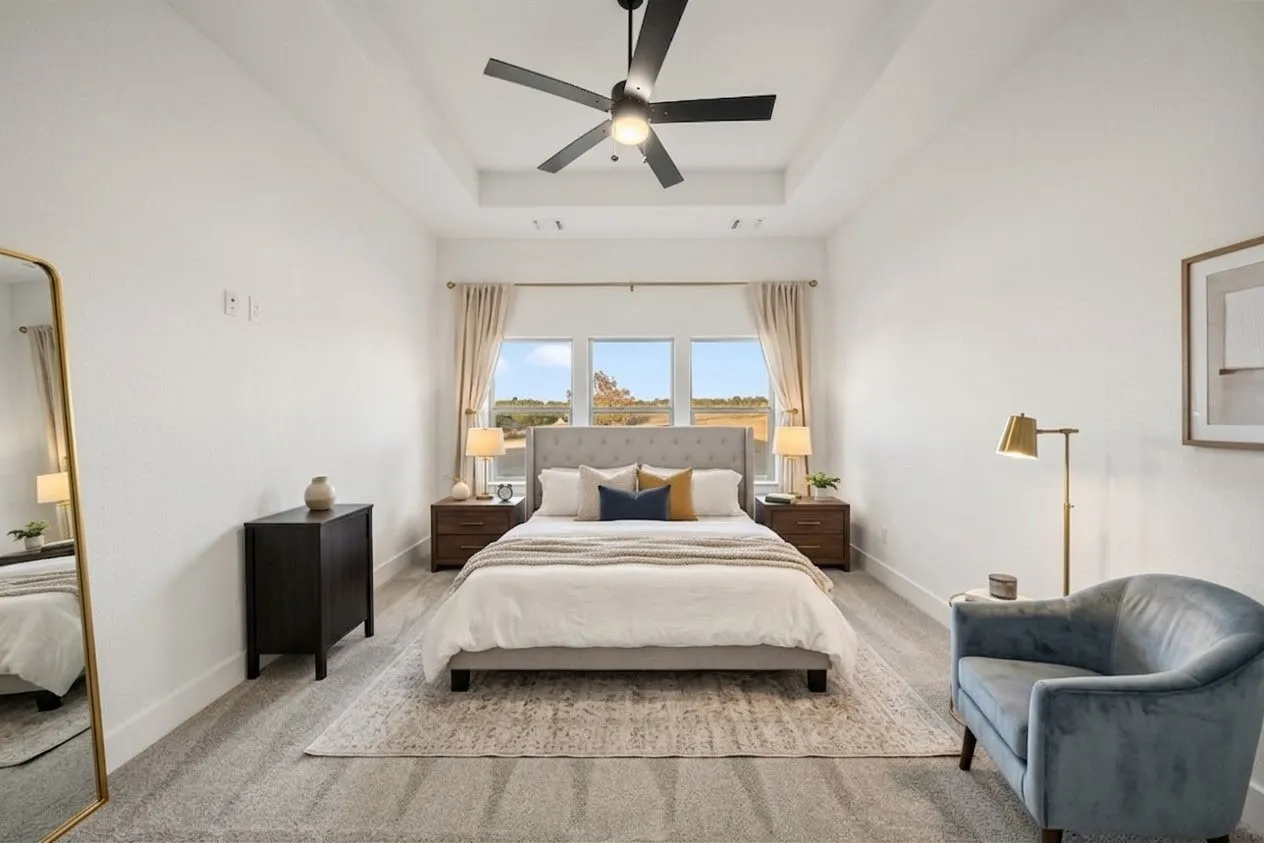 Tray ceiling with a black ceiling fan, recessed lighting, and wall-to-wall carpeting