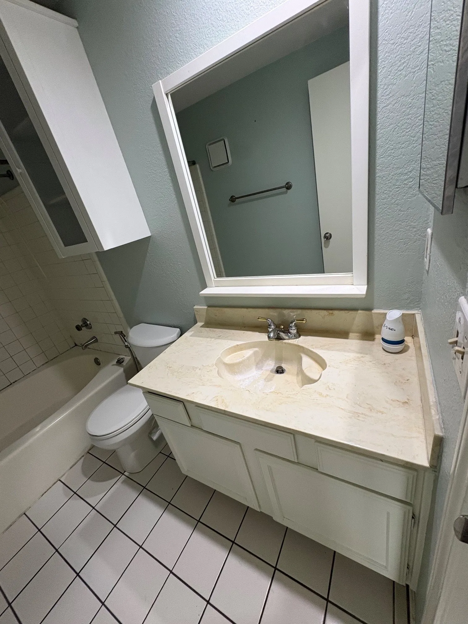 Bathroom vanity with framed mirror.