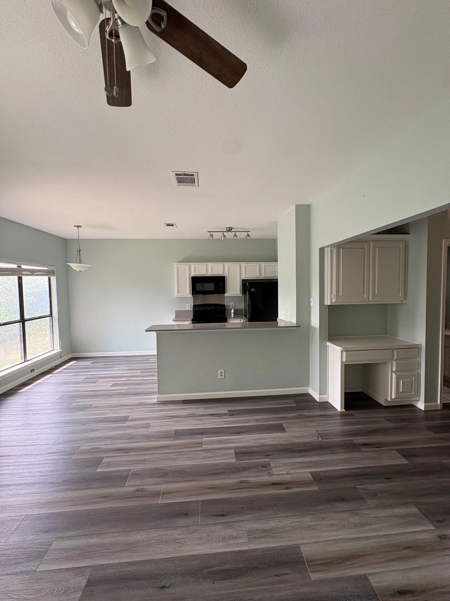 Living room is open to kitchen and dining area.