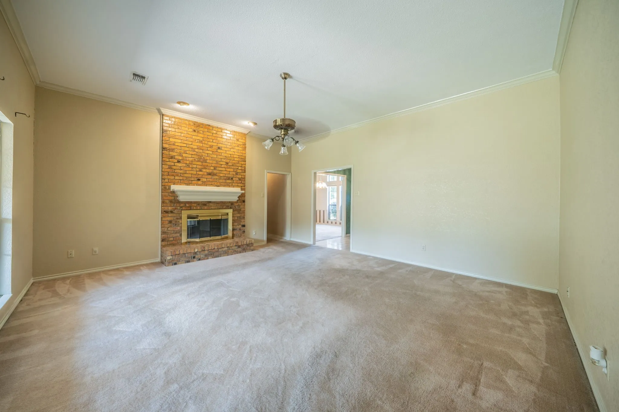 View of family room standing in the entry to hall to primary bedroom.