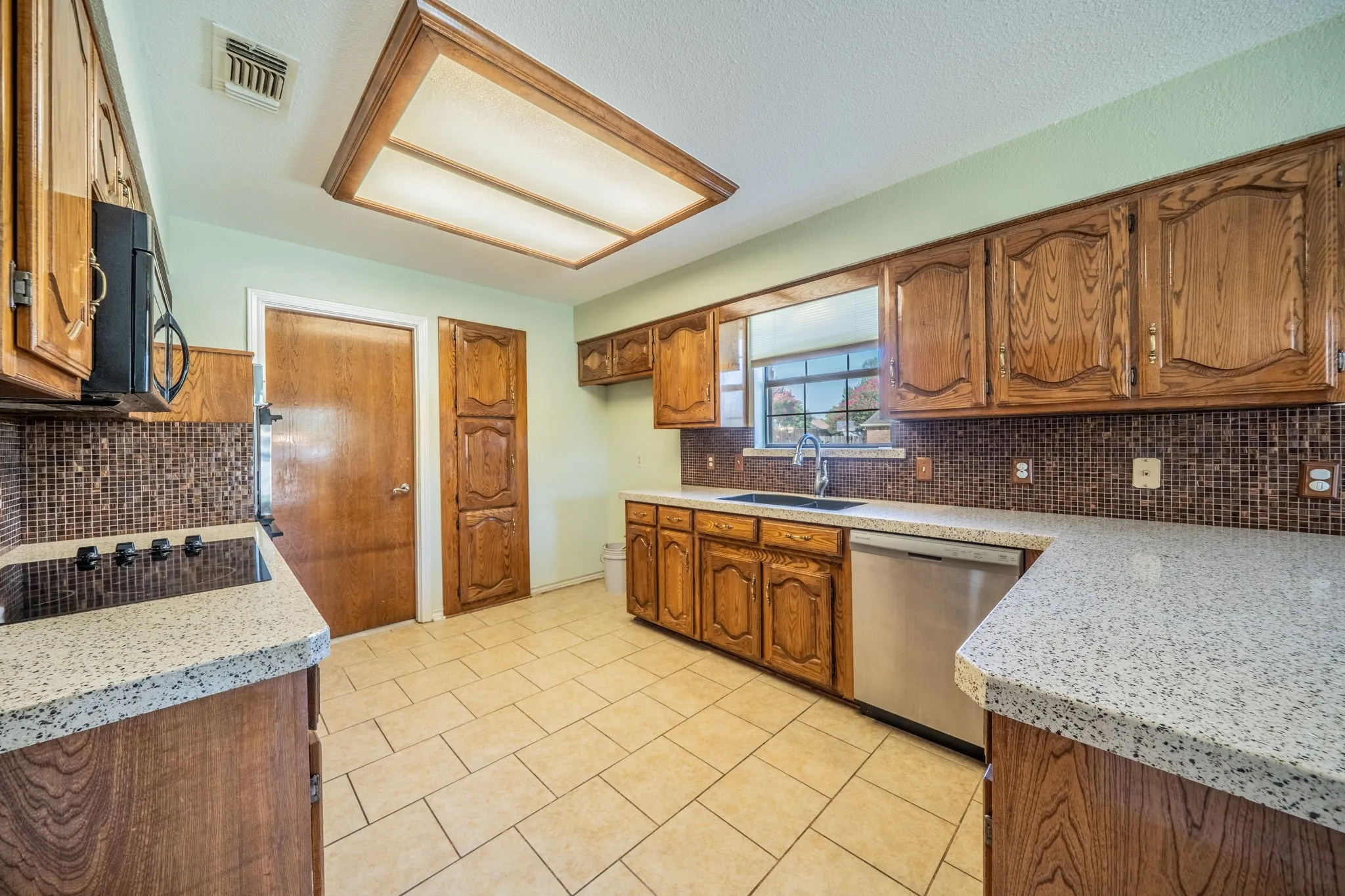 Kitchen has window facing the side of corner lot.  Farmhouse composite sink is a nice upgrade.