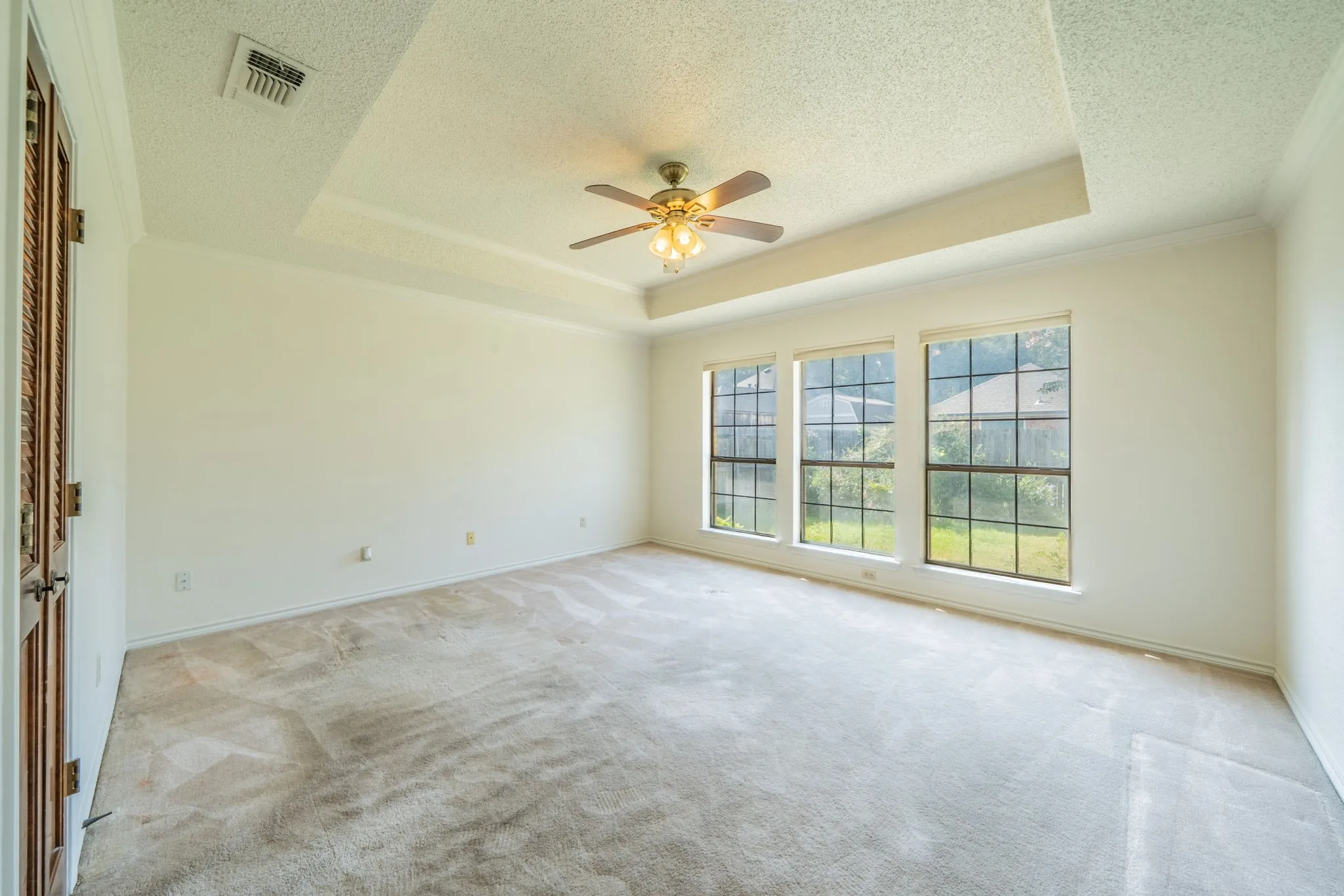 Primary bedroom is a nice size and has ensuite bath.  It is on one side of family room.  Hallway has a door to backyard so you can easily go outside as needed.