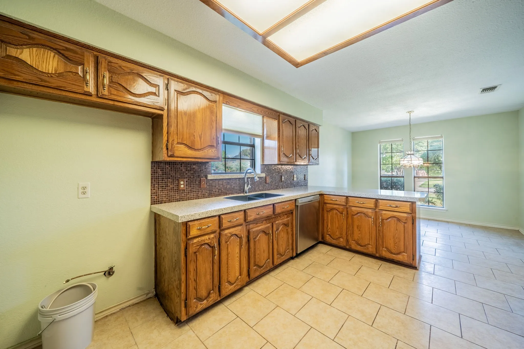Full view of kitchen standing in the space to head to garage.  Easy to unload car straight into kitchen.