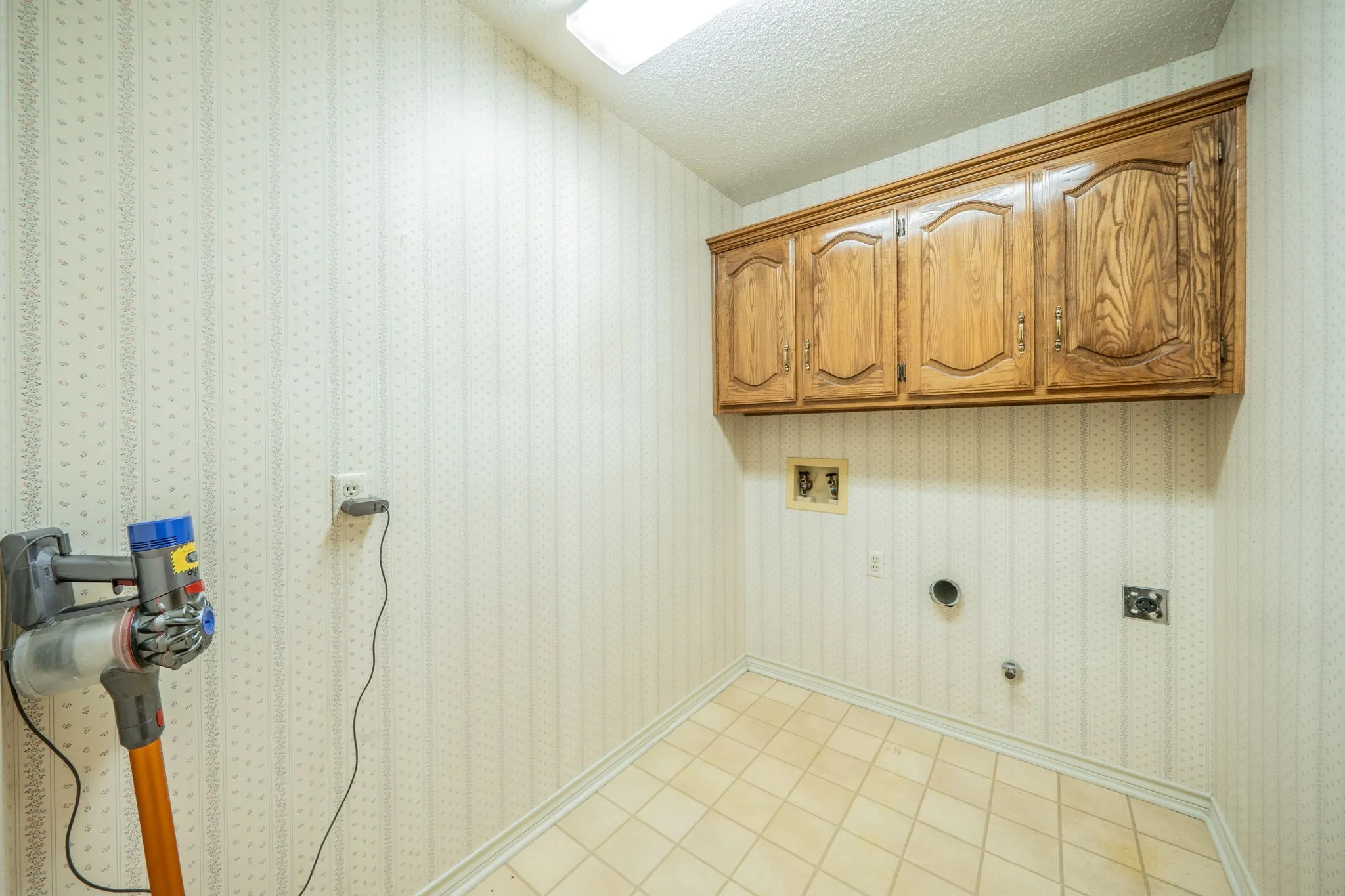 Good sized laundry room is down the hallway from the kitchen.  Centrally located for the entire family.  Has built in cabinets and room for a second fridge or freezer.