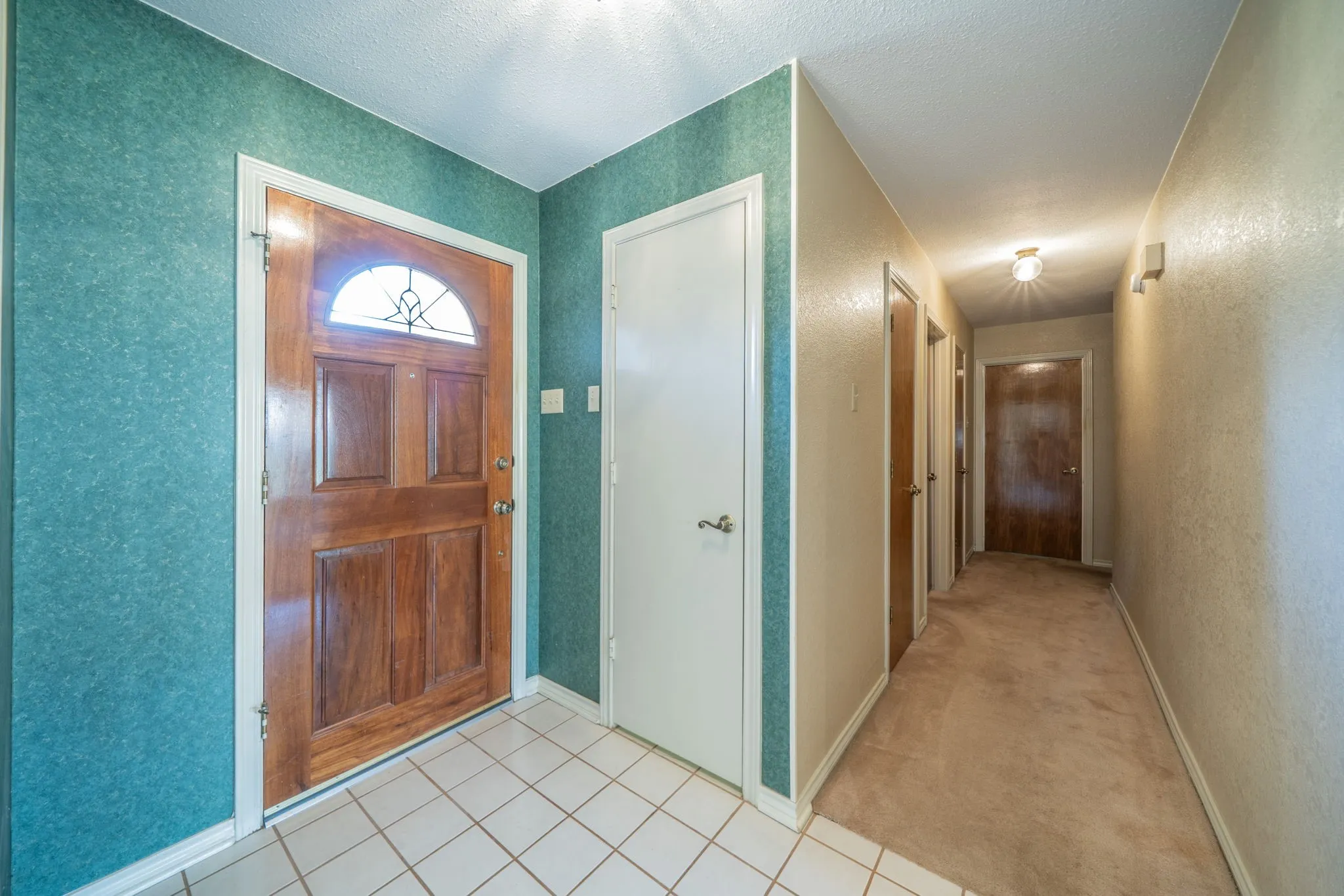 Entry and hallway to secondary bedrooms.