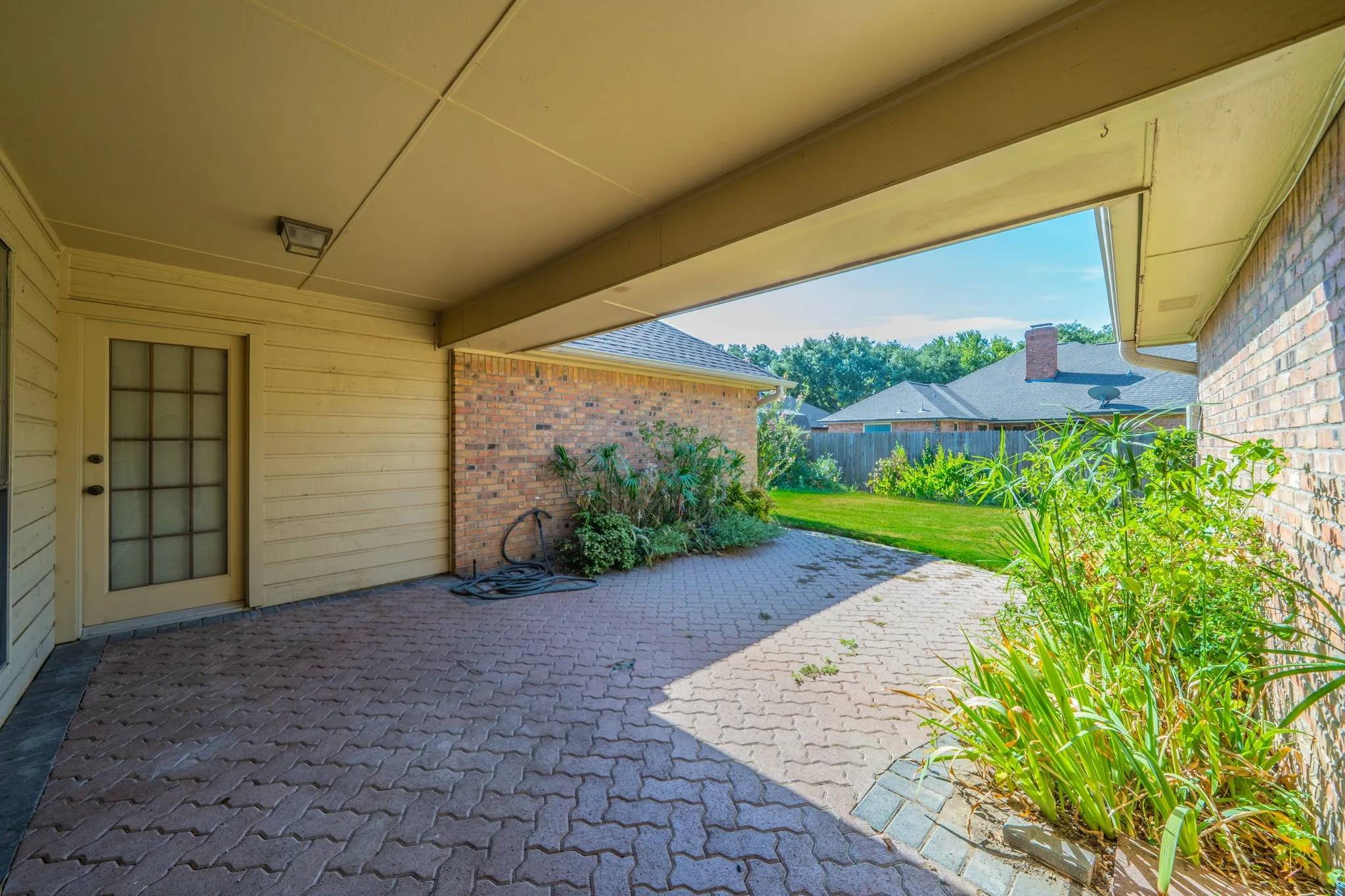 Great backyard with large covered patio.  Entrance thru garage or the door here goes into the hall going to the primary bedroom.