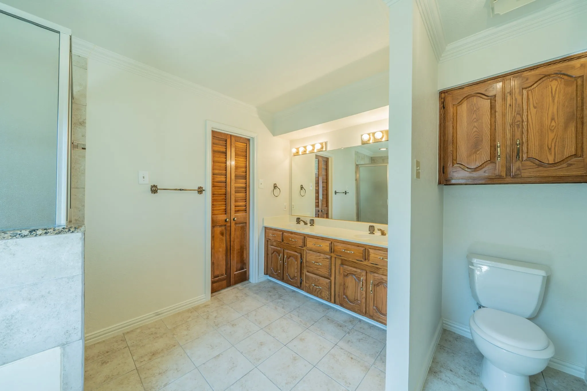Primary bathroom was also freshly painted.  Note dual sinks and privacy wall for toilet.