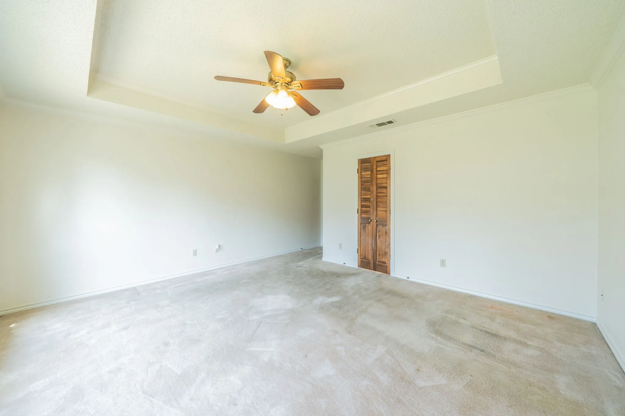 The room was just painted and has a tiered ceiling.  Door enters bathroom and has nice walk in closet.