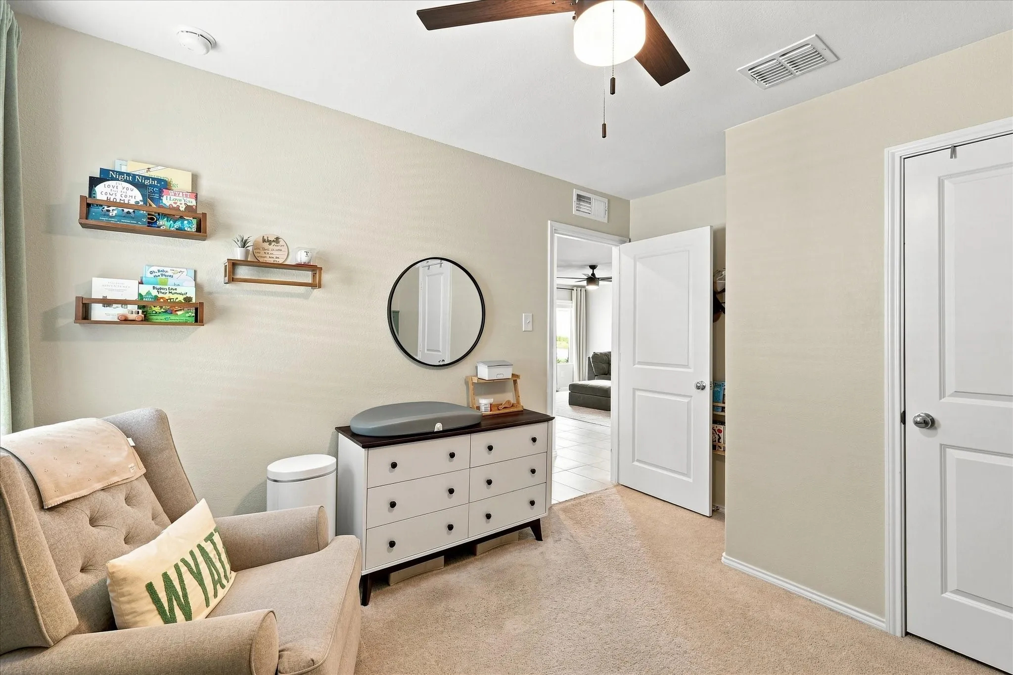 Carpeted flooring, ceiling fan with integrated lighting, and multiple white paneled doors