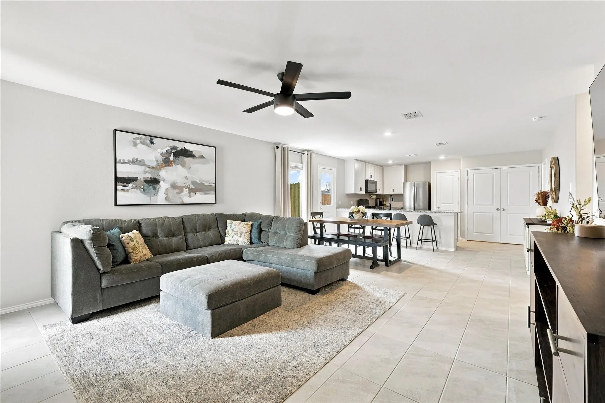 Open concept layout with neutral walls, recessed lighting, and a modern ceiling fan