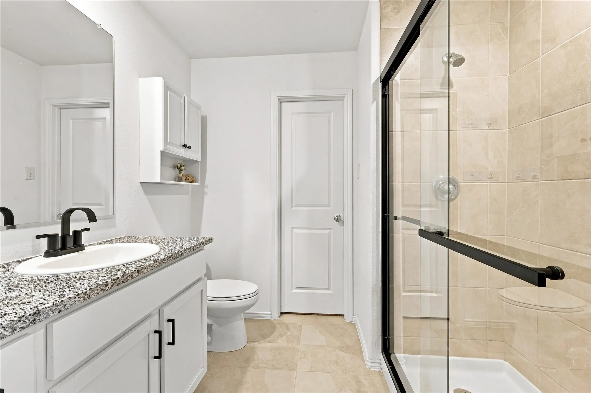 Vanity with granite countertop, undermount sink, and matte black faucet