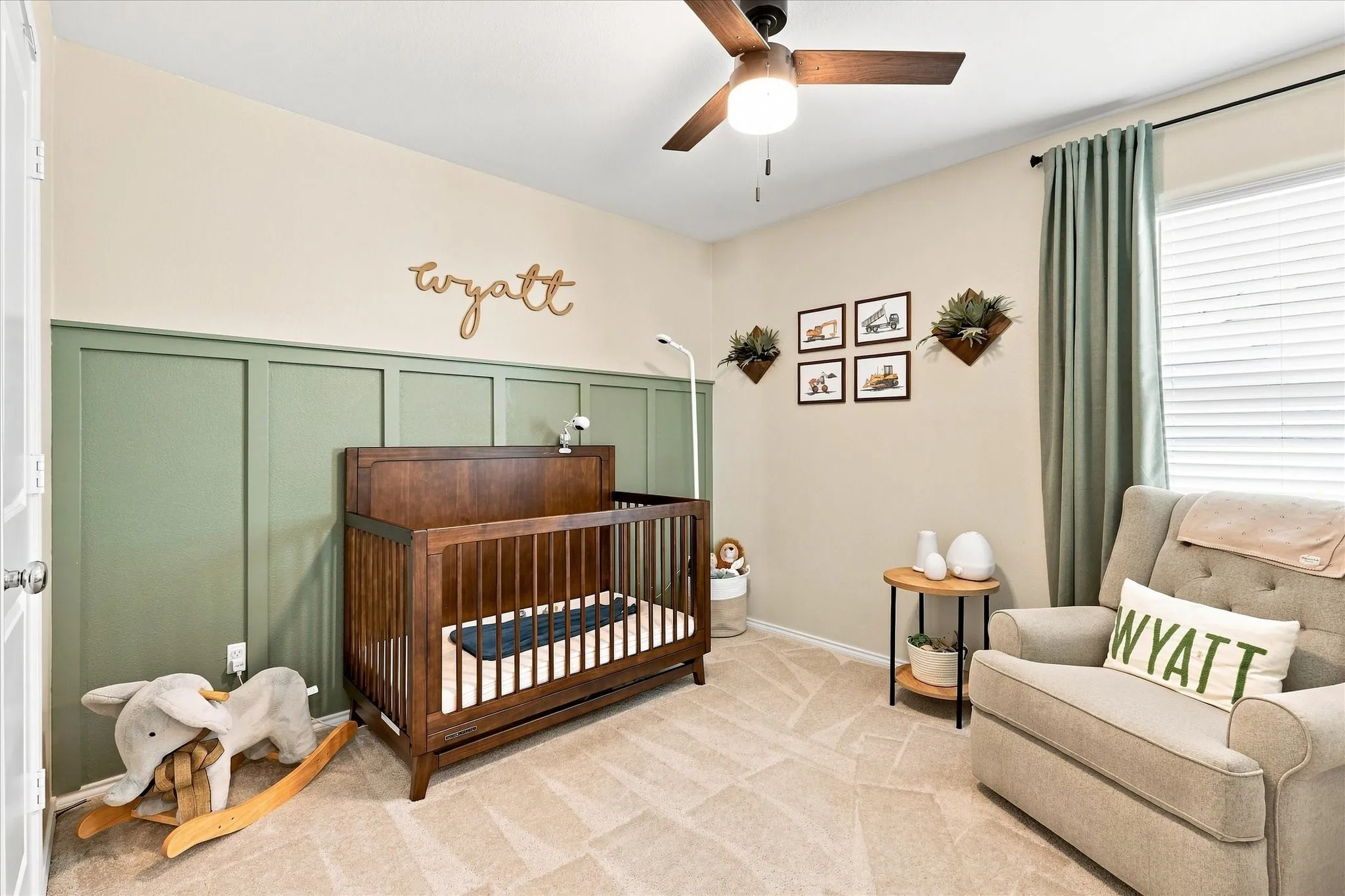 Ceiling fan with integrated lighting, window with blinds, paneled accent wall, and wall-to-wall carpet