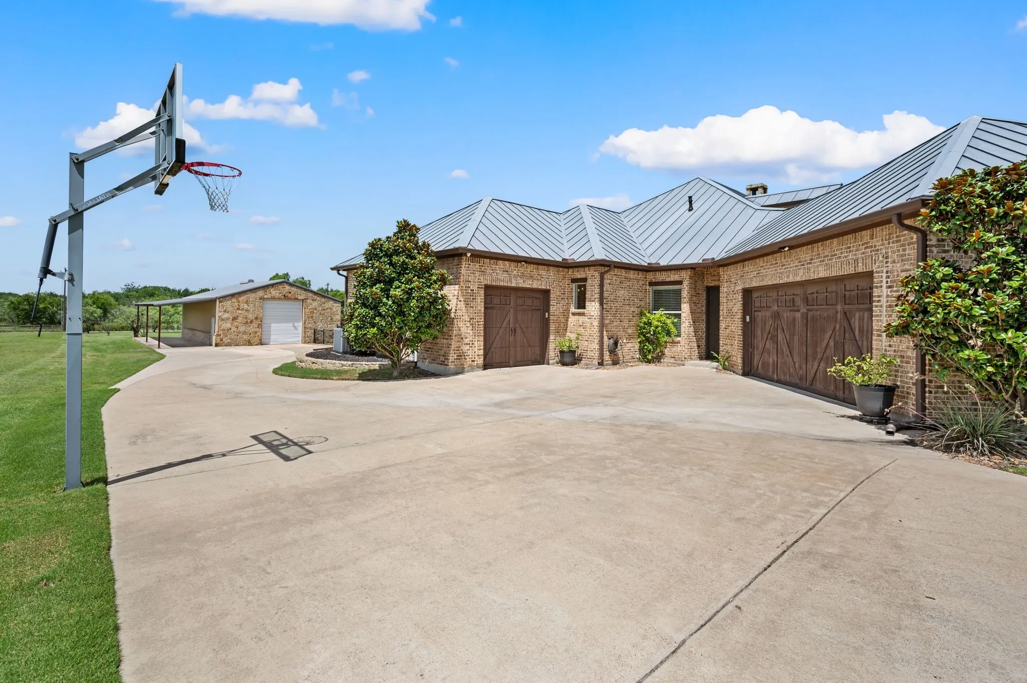 A large rear motor court provides extensive parking, a 3 car garage, & convenient access to the detached workshop.