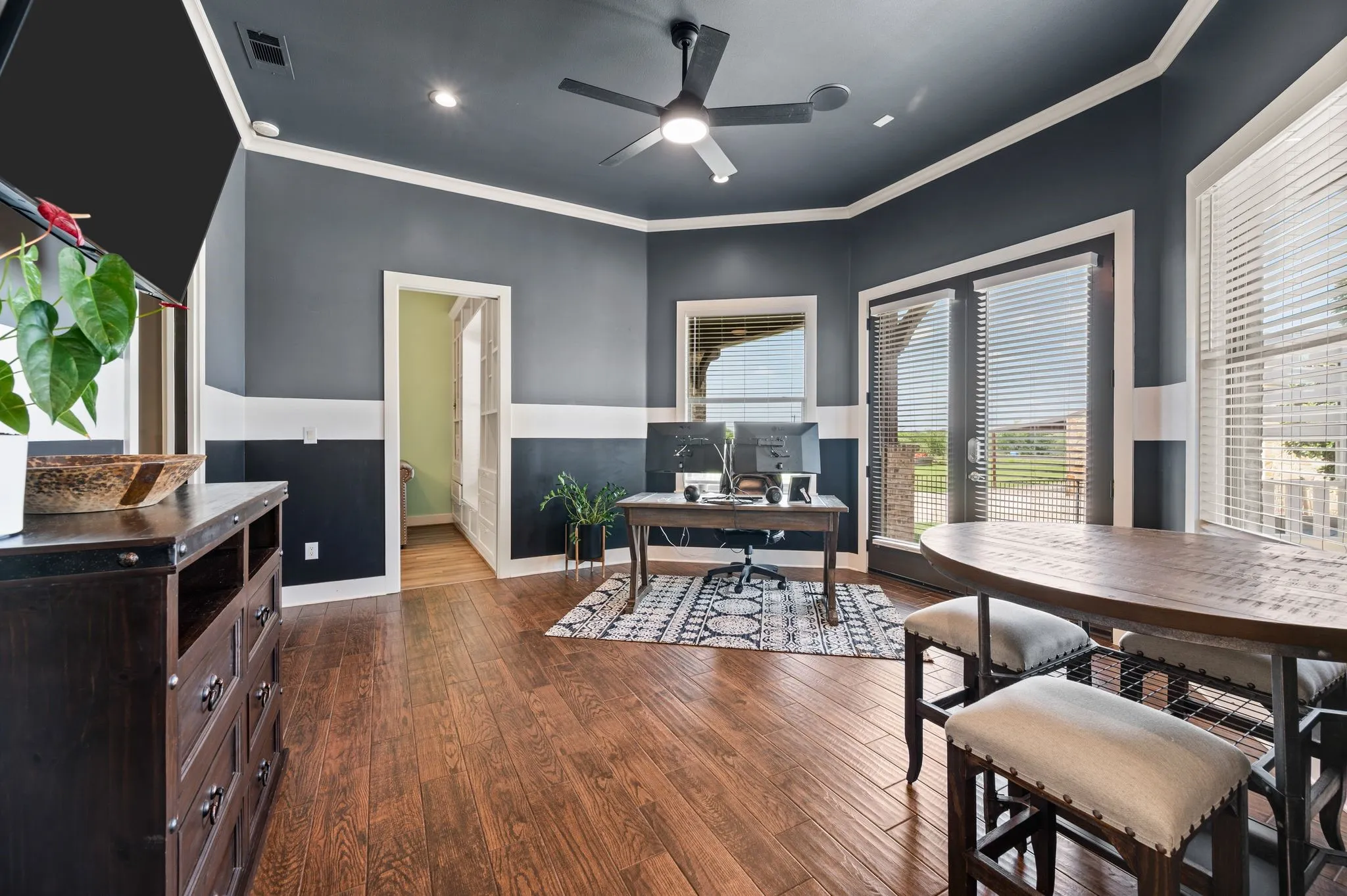 A spacious flex space offers an abundance of natural light, patio access & plenty of room for work or play.