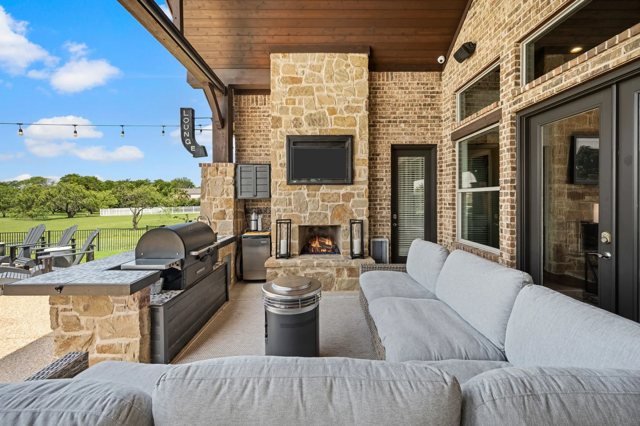 Outdoor entertaining is effortless with a bar area and stone fireplace!