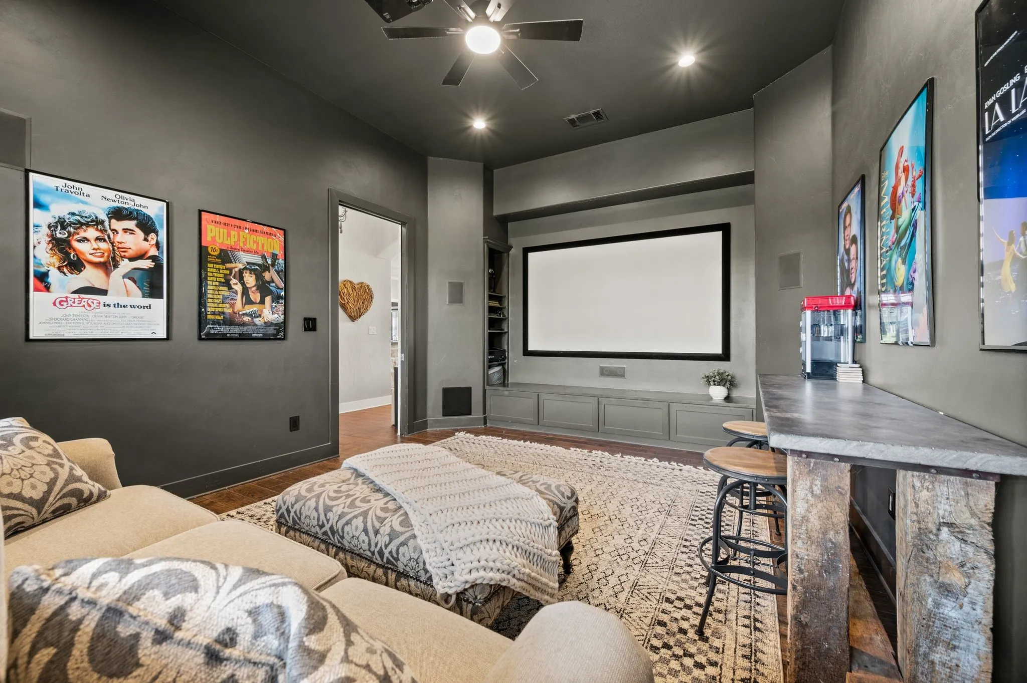 Bring the theater experience home with a large projection screen, built-in cabinetry and built in speakers!
