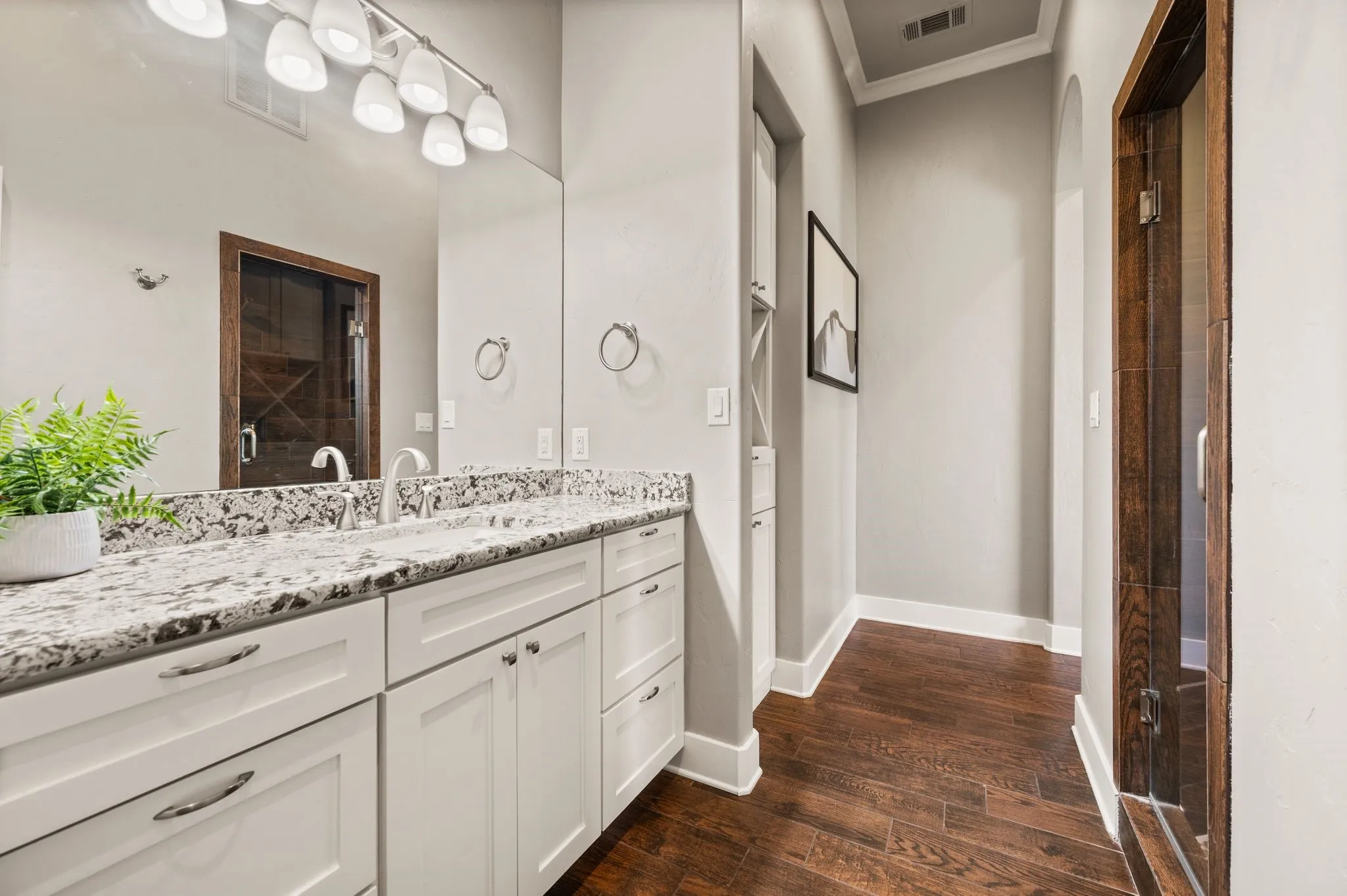 The primary bathroom offers his and her vanities and his and her water closets!