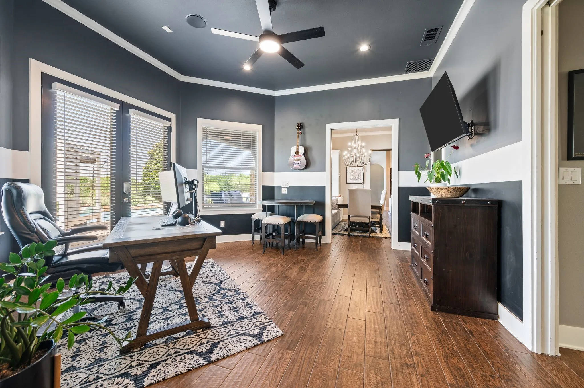 Another view of this versatile room highlights its generous proportions  & convenient connection to the dining area.
