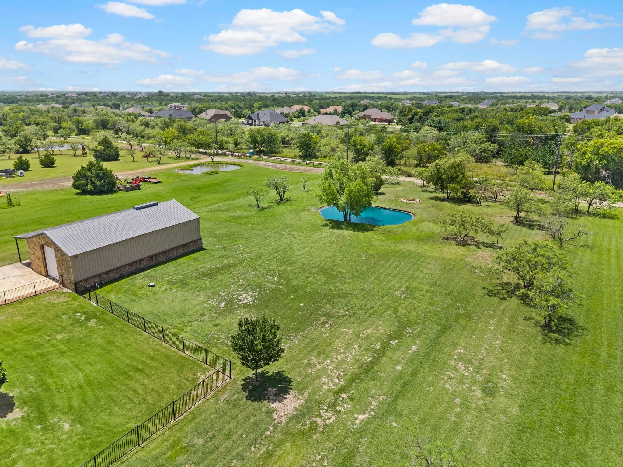 Expansive acreage, a private pond, mature trees & a substantial workshop offer an exceptional blend of space, beauty & versatility.