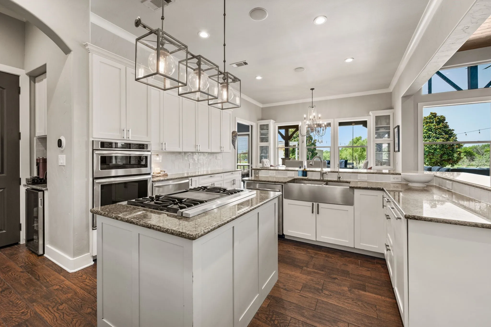 A dedicated cooking island with a commercial grade Viking gas cooktop, a warming drawer, farmhouse sink & plenty of cabinetry makes this kitchen as functional as it is beautiful.