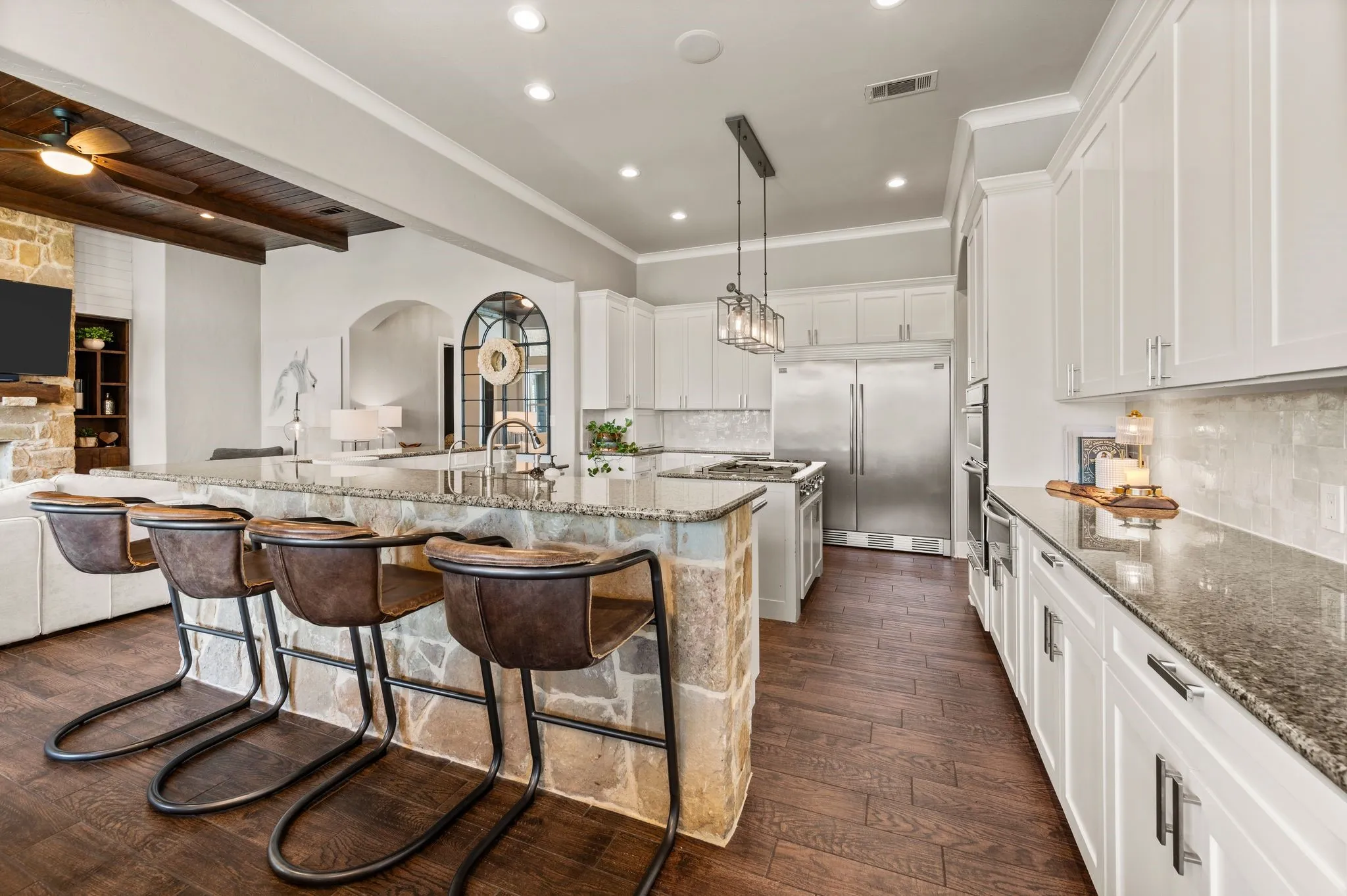 Designed for entertaining, this open kitchen offers abundant prep space, generous seating & direct connection to the living room.