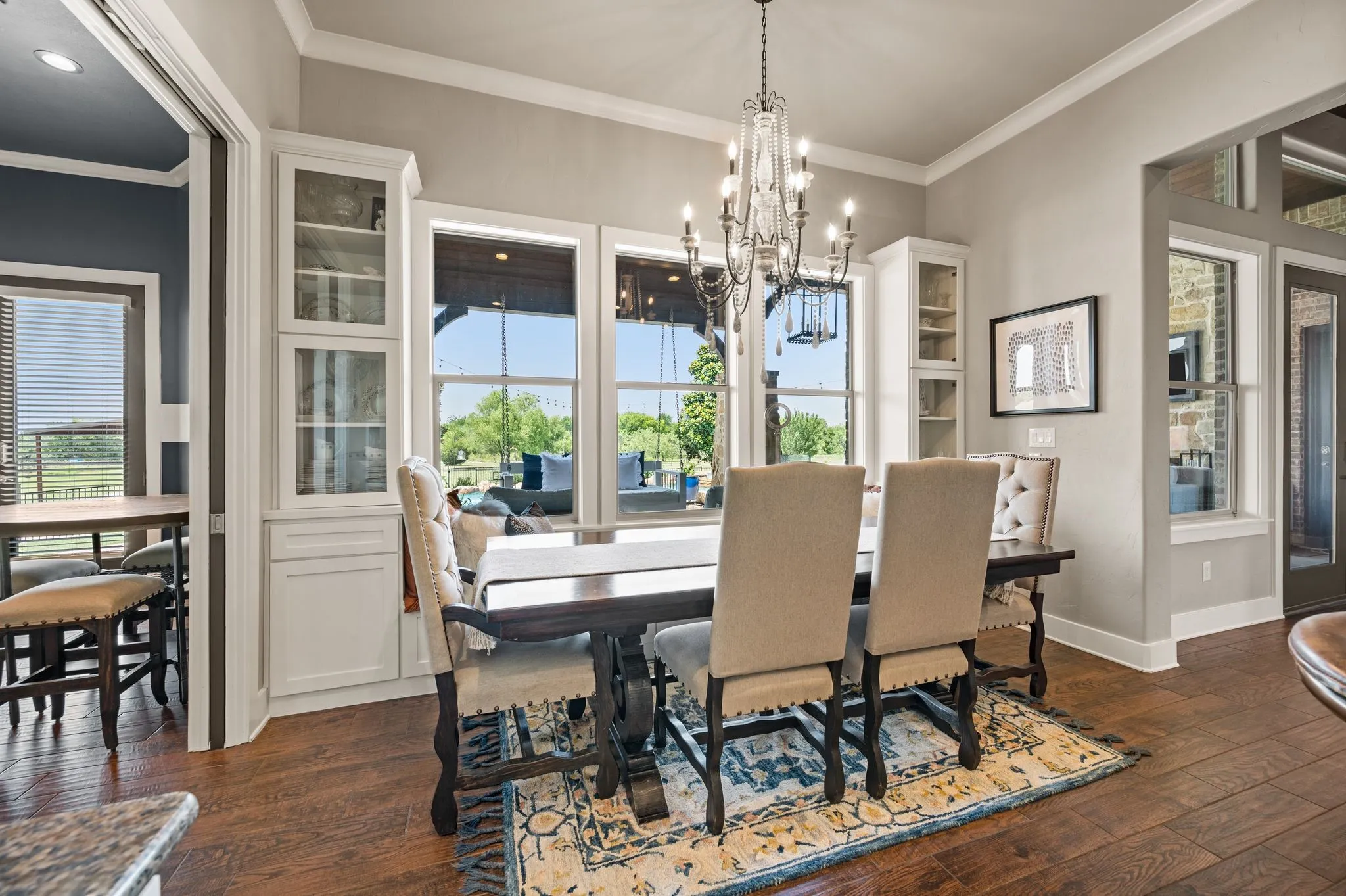 A second view of the dining area showcases abundant natural light, beautiful built-ins & easy access to the kitchen and outdoor living space.