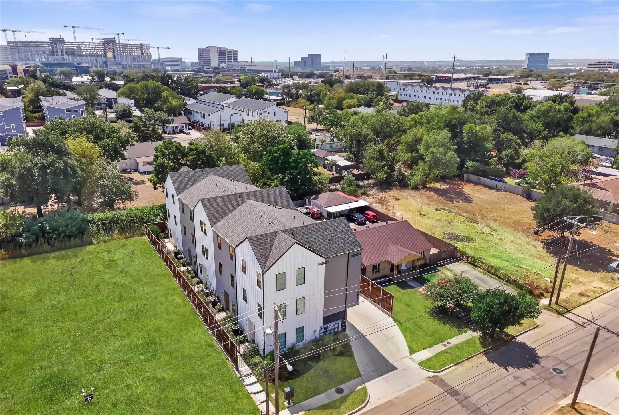 Newly constructed townhomes featuring modern exteriors, multiple levels, and private fenced yard space