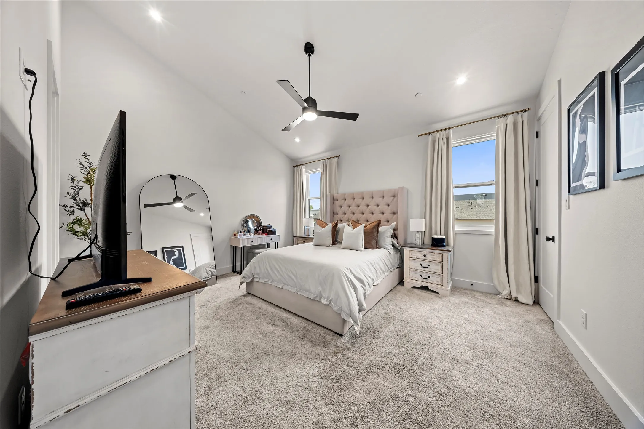 Vaulted ceilings, recessed lighting, and a contemporary ceiling fan