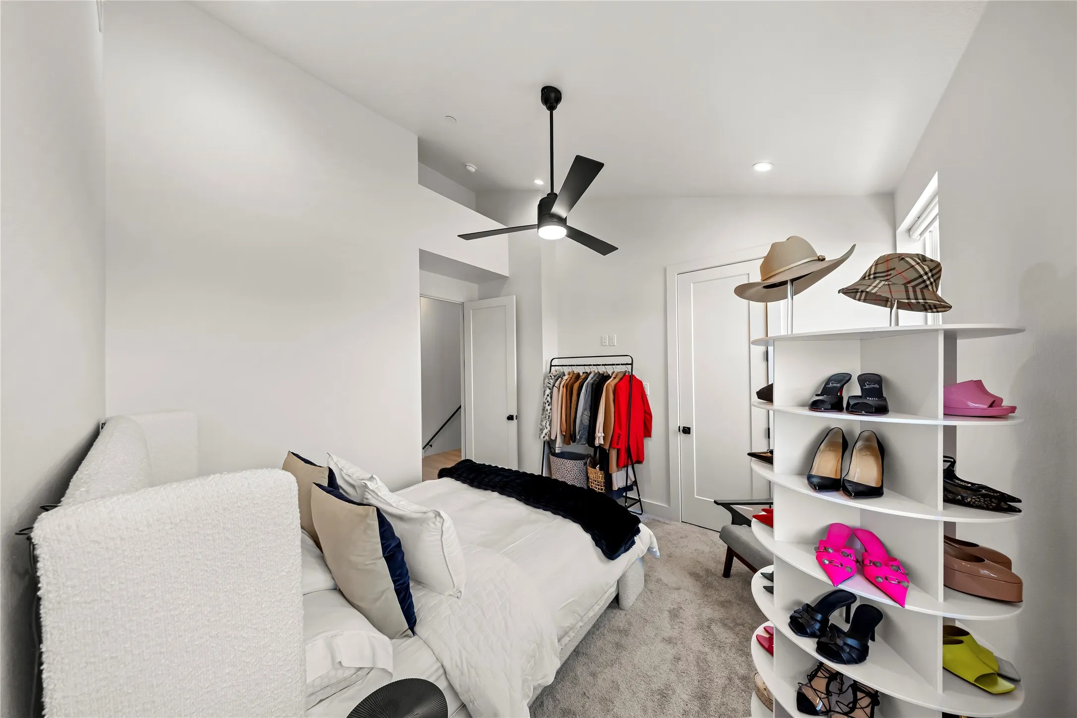 High ceilings with a contemporary ceiling fan, recessed lighting, and a white interior door