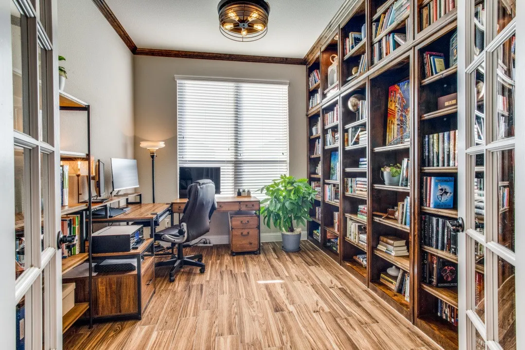 Wood-finish flooring, built-in shelving, white French doors, and a wood-beamed ceiling