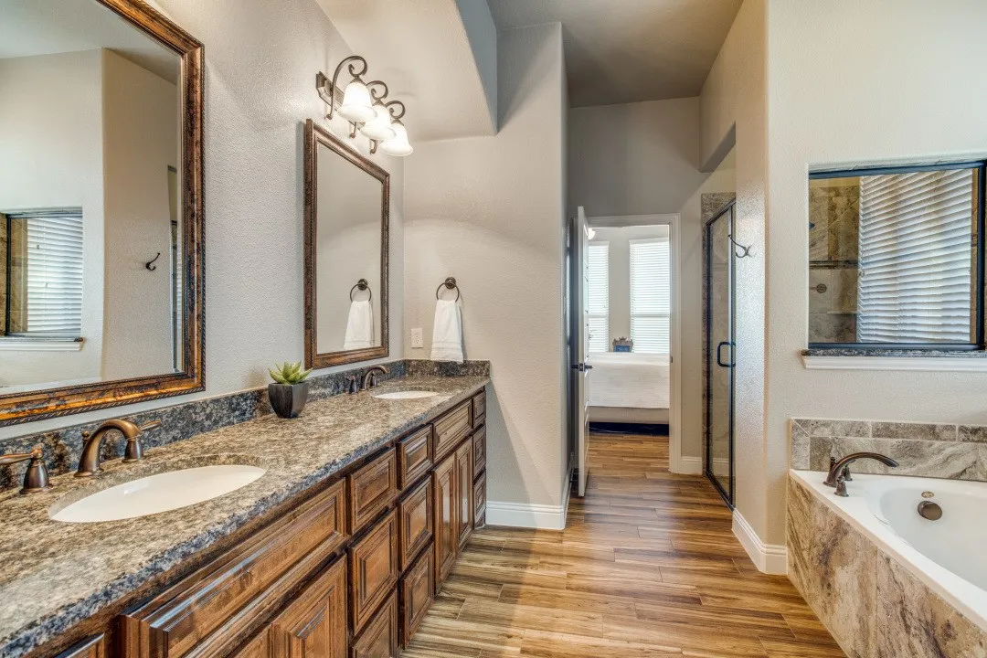Dual vanity with integrated sinks, expansive countertop, and wood-finish cabinetry