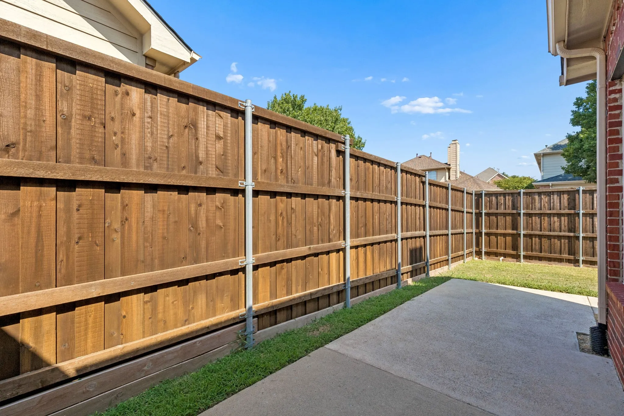 Wood board on board privacy fence and patio area