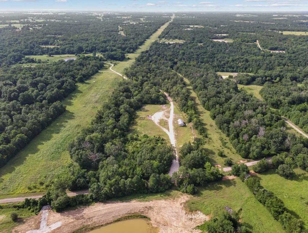 View of property location featuring a heavily wooded area