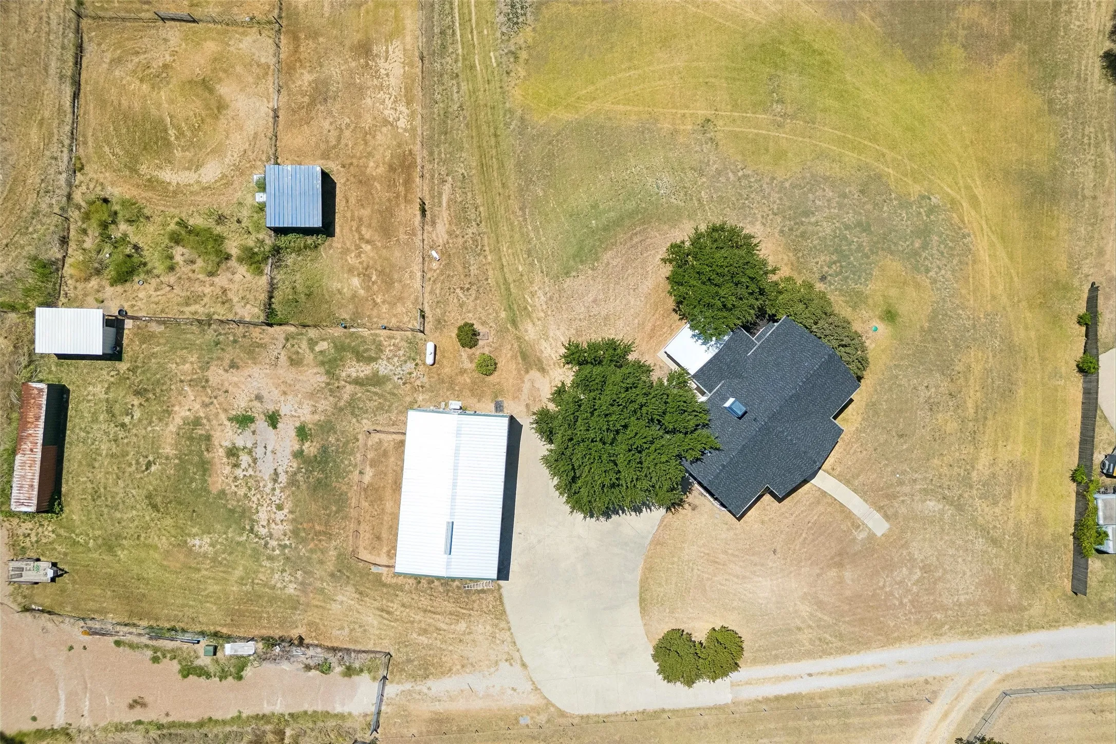 Aerial shot of the home, shop and other structures on property.