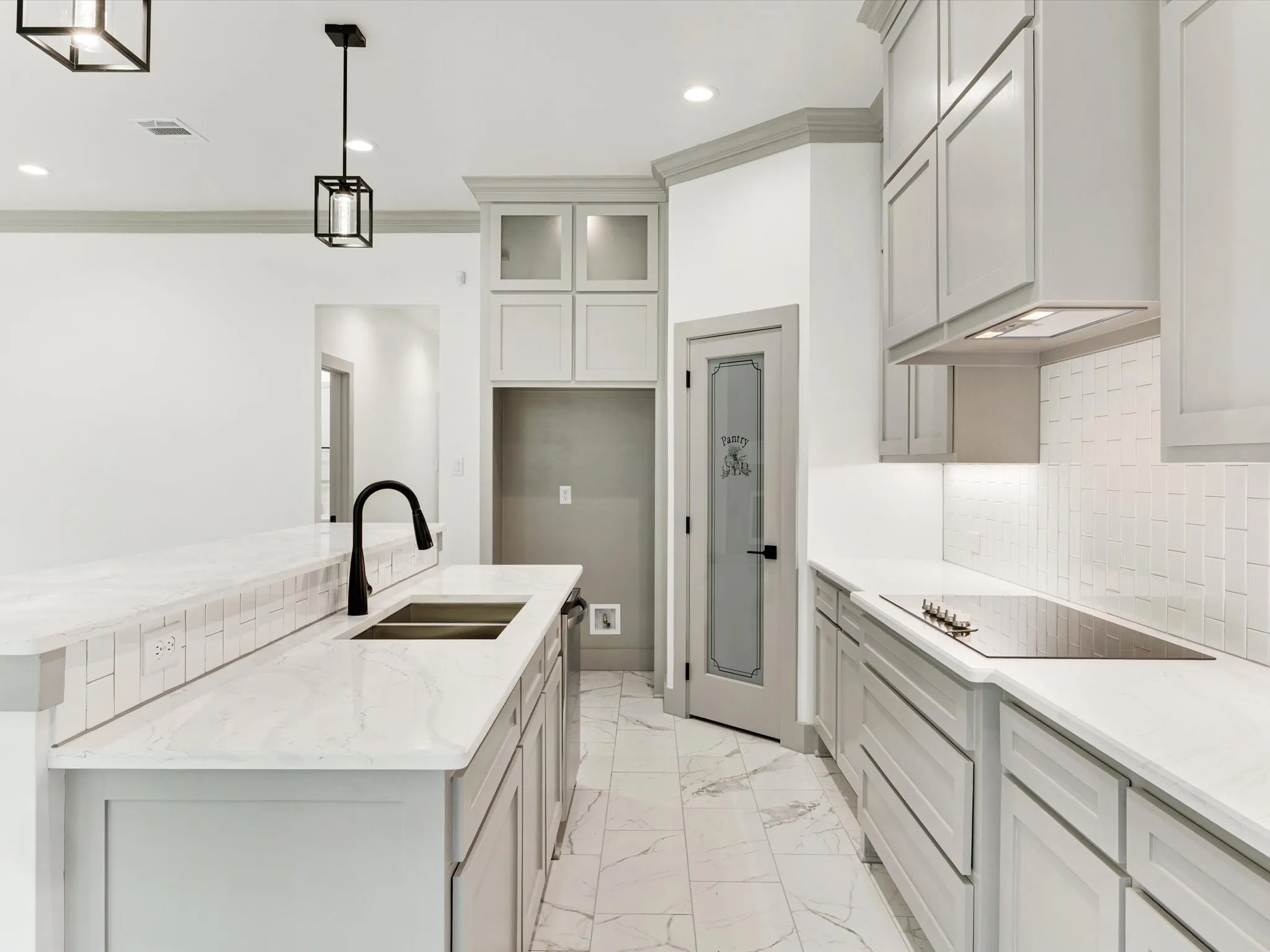 Kitchen featuring light-toned cabinetry, white countertops, tile backsplash, and recessed lighting