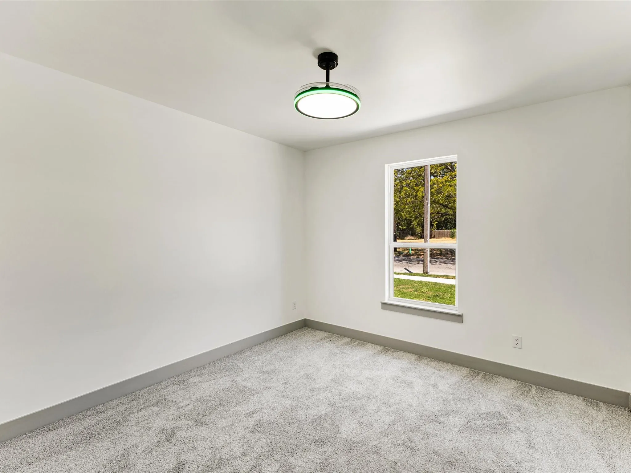 Recessed window with white trim, light gray wall color, gray carpeting, and a modern ceiling light fixture